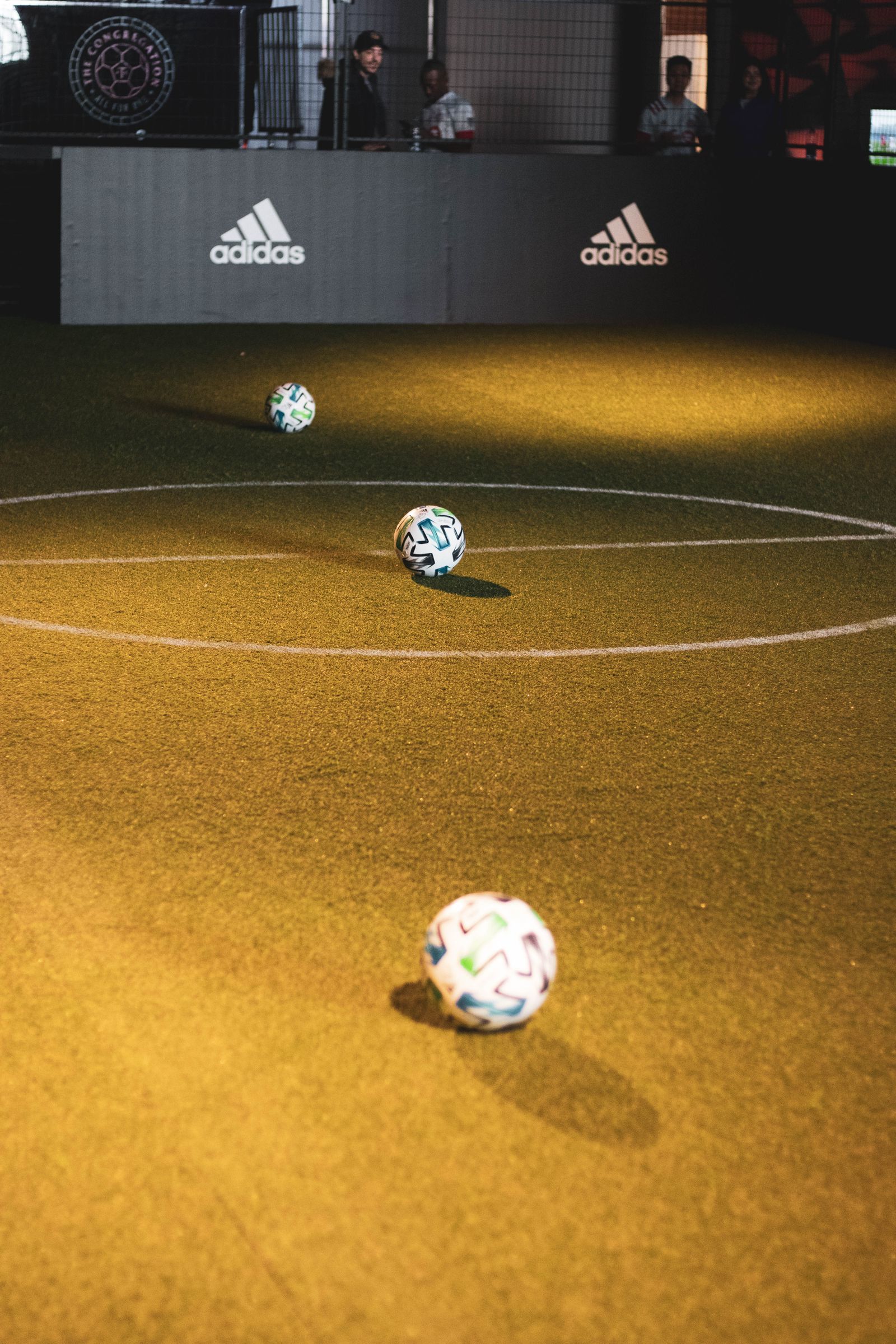 Indoor futsal court with soccer balls on turf