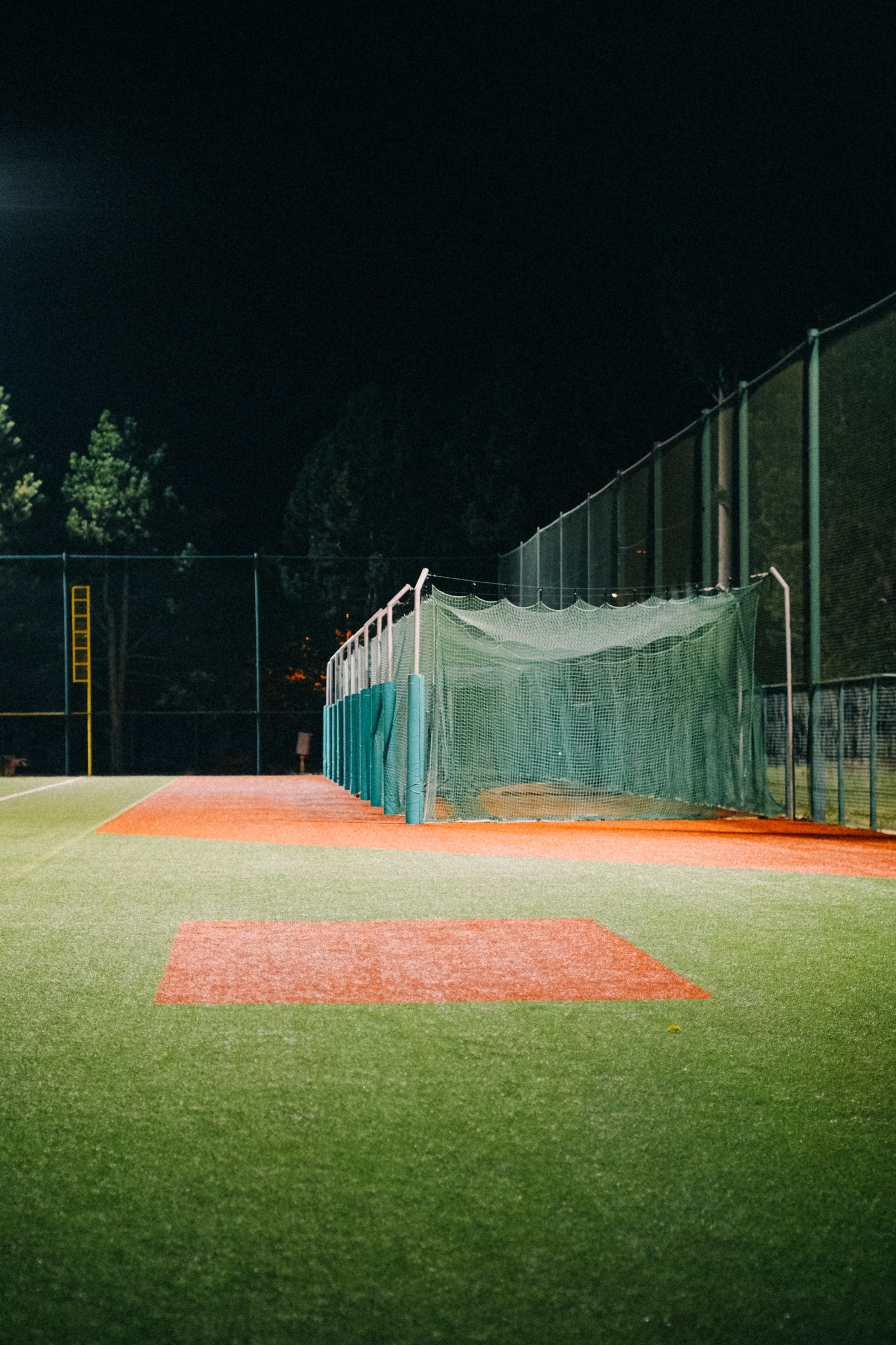 Brightly lit indoor turf sports field at night