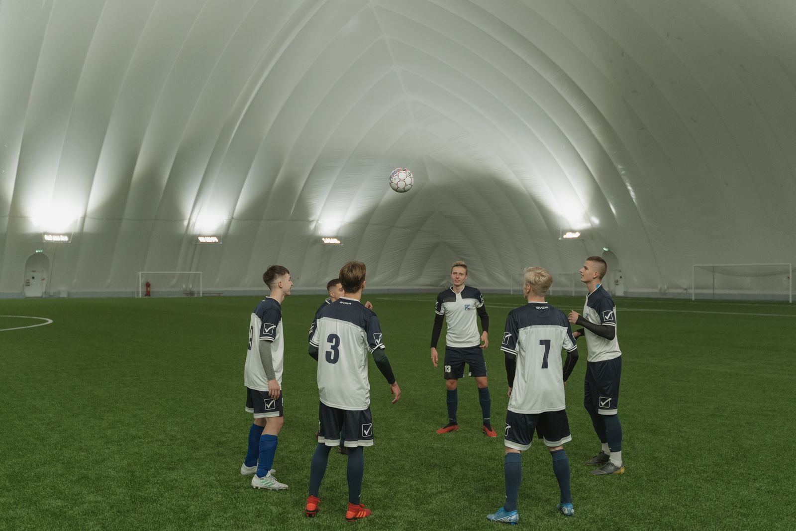 Team practicing on indoor artificial turf field