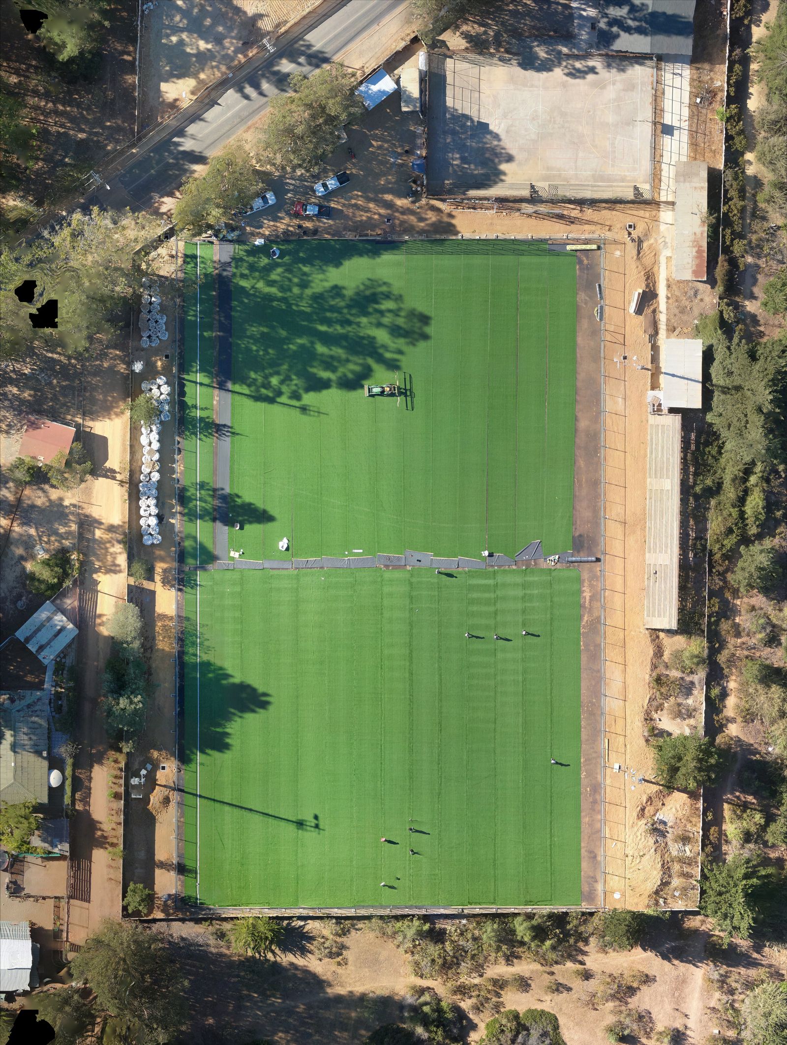 Aerial view of a turf field surrounded by trees