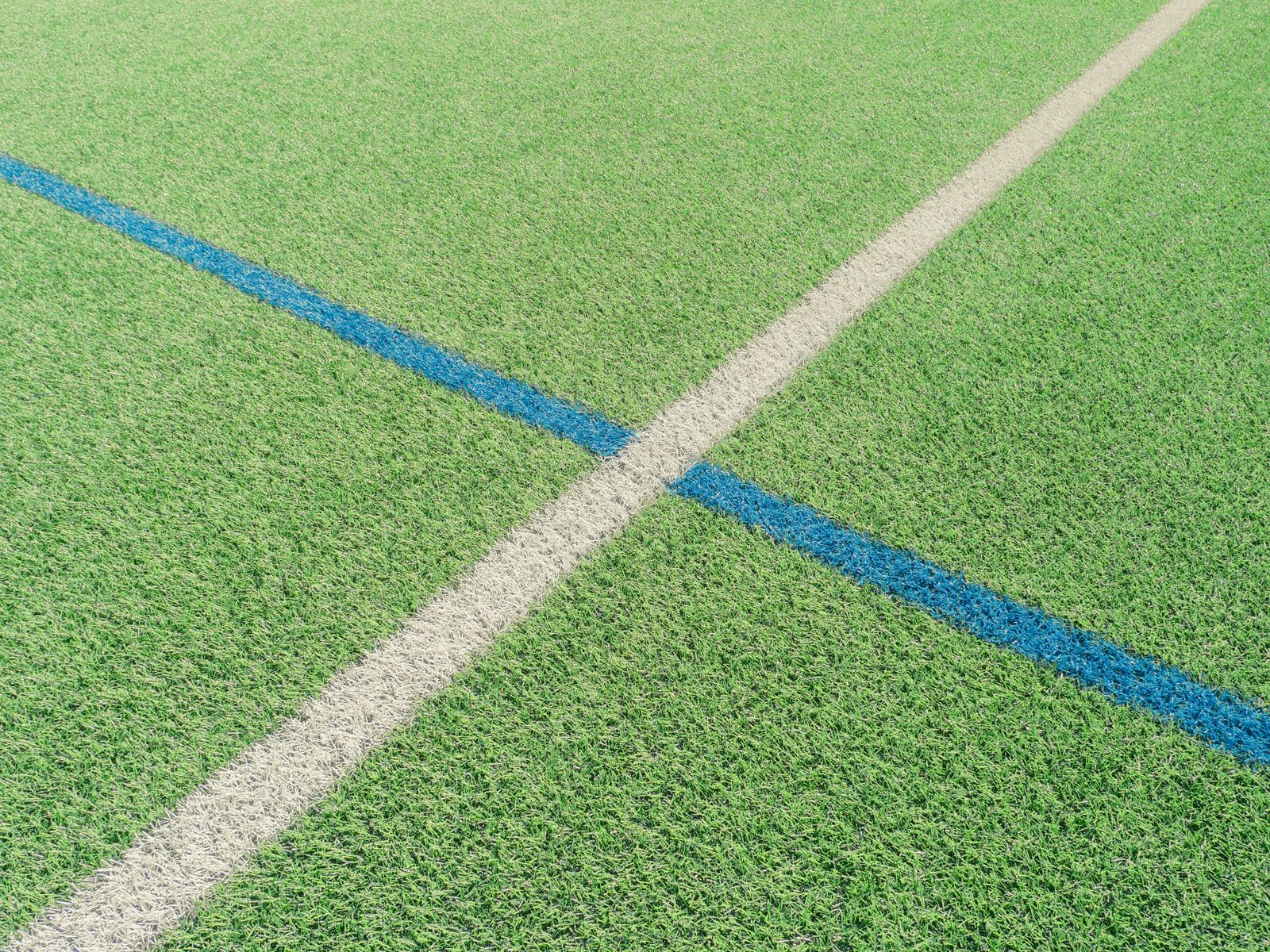 Close-up of intersecting line markings on a multi-sport turf field